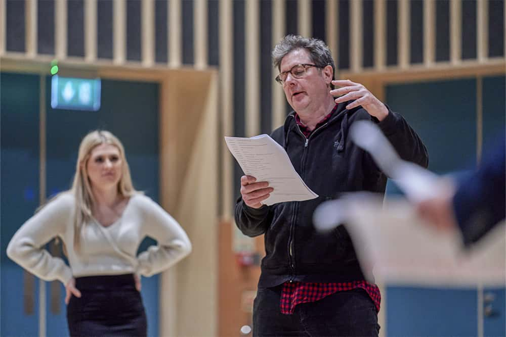 Acting students rehearsing from scripts