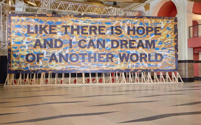 Large scale painted installation in the Bank Plain building at Norwich University of the Arts reads 'Like there is hope and I can dream of another world'