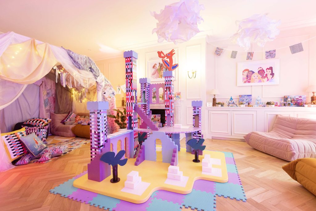 A photo of a room in the Disney Playhouse in London. The room is pink, purple and yellow and has a poster of Disney princess characters upon the wall. Picture credit: Matt Alexander/PA Wire