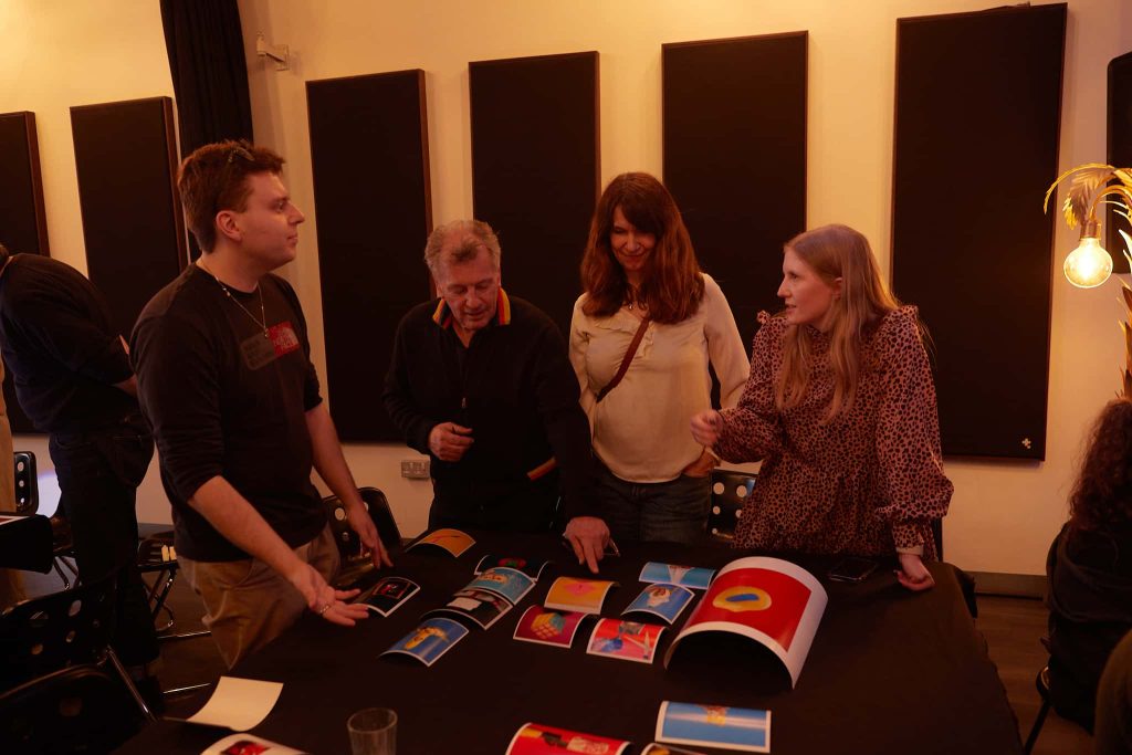 Andy Earl, Amy Foster, Emily Salmon and Joey Rolph are stood around a table of Joey's work