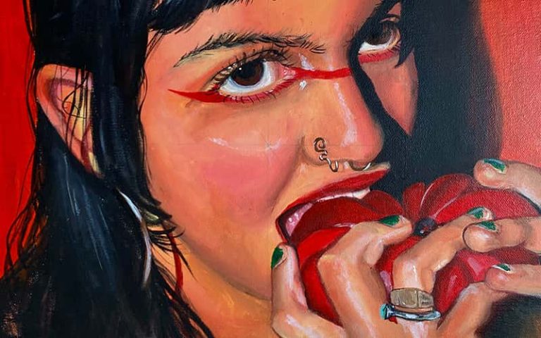 'The Love They Share', by Yasmin Shah. Painting of a person with long black hair biting into a red fruit. Both hands hold the fruit in front of the face, and a red line is painted below the eyes.