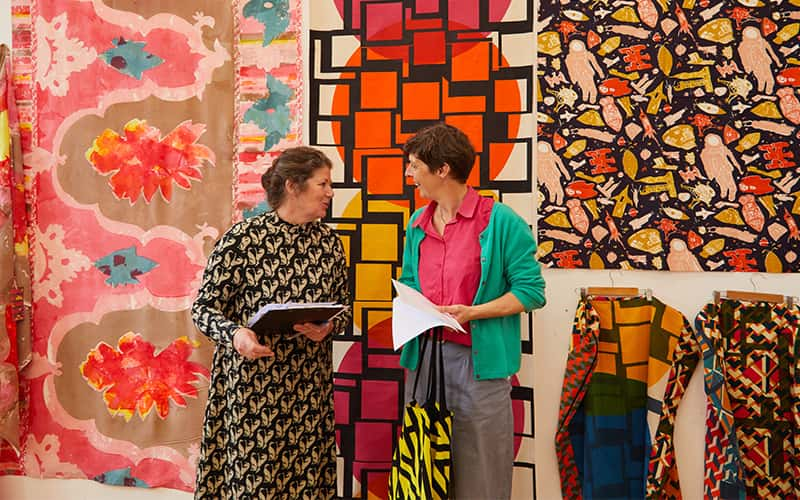 Two women talking to one another at the Textile Design Industry Awards