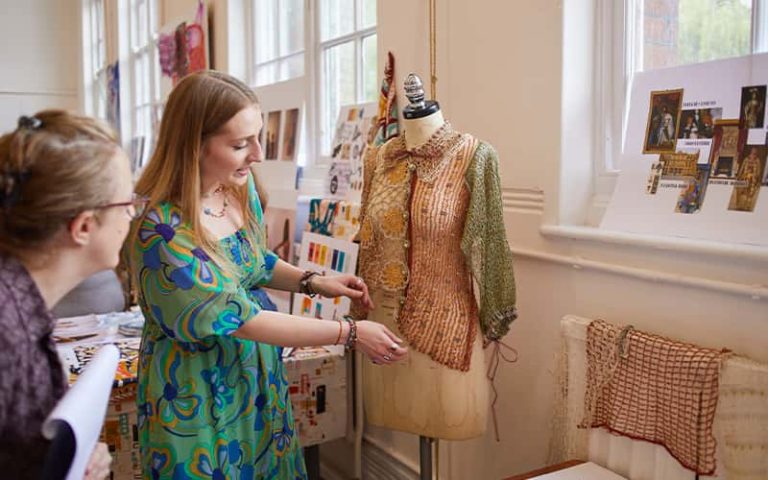 A BA (Hons) Textile Design student talking to a judge at the Textile Design Industry Awards