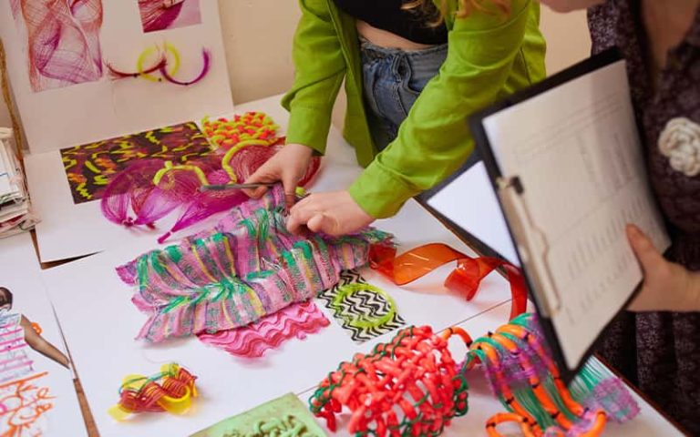 A BA (Hons) Textile Design students work laid out on a table at the Textile Design Industry Awards