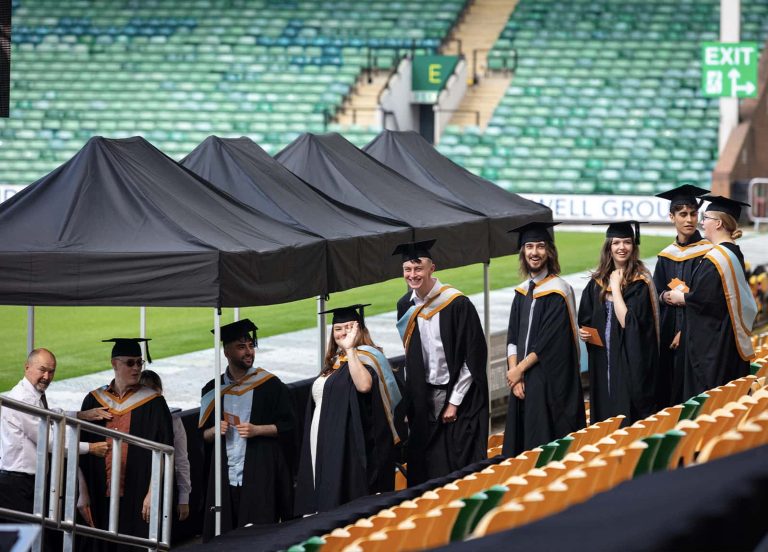 A photo of Norwich University of the Arts graduates waiting in a line, before going on stage at Graduation 2023.