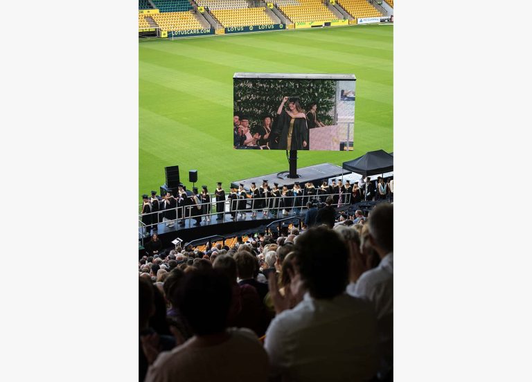 A photo of Norwich University of the Arts graduates lining up before going on stage at Graduation 2023.