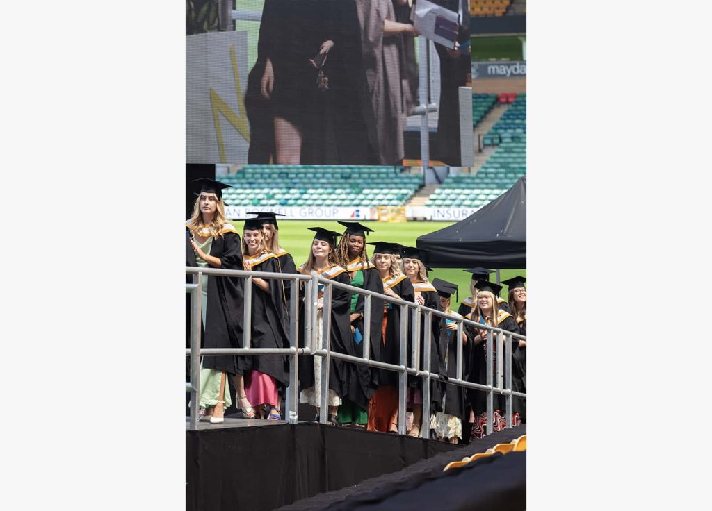 A photo of Norwich University of the Arts graduates lining up before going on stage at Graduation 2023.