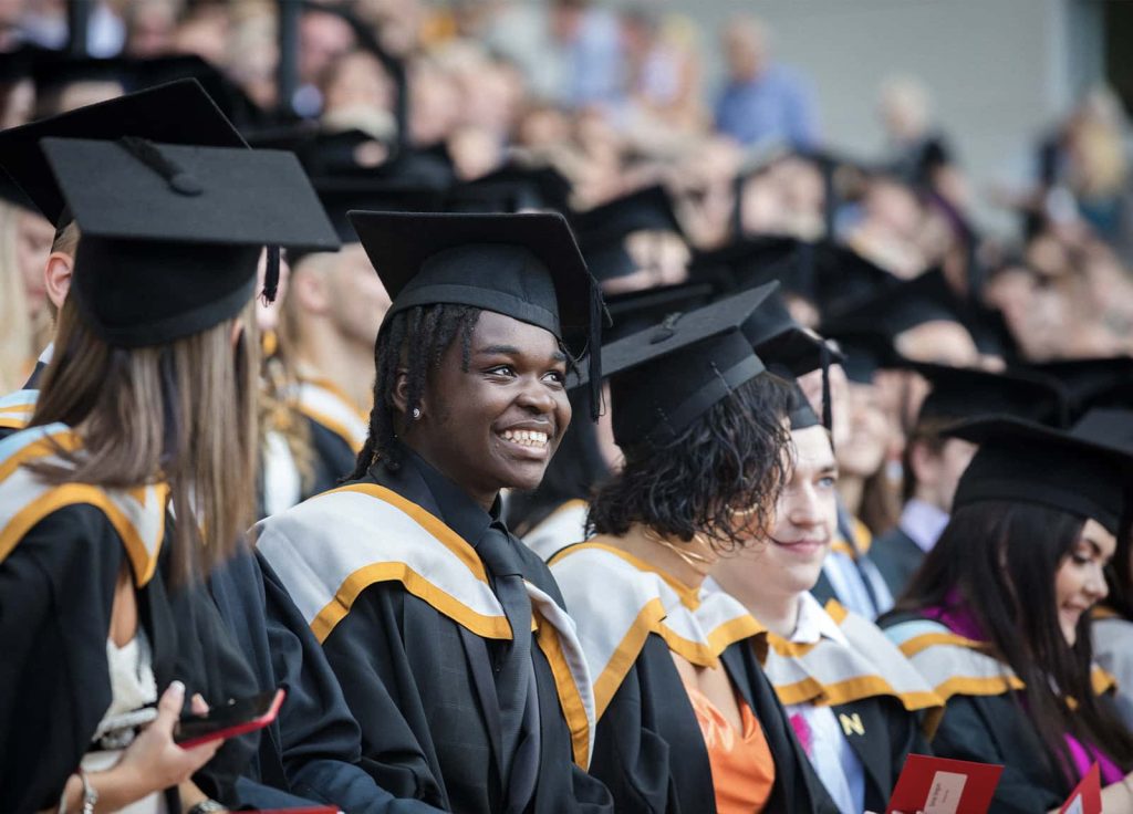 A photo of a student smiling at Graduation 2023.