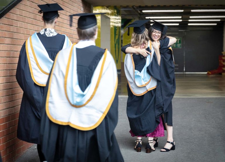 A photo of two Norwich University of the Arts graduates hugging at Graduation 2023.