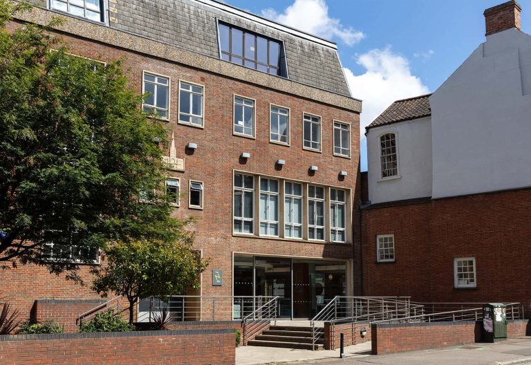 A photo of St. Andrews House on a summers day.