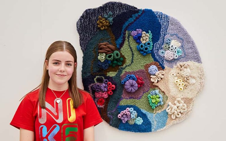 Beatrix Ellerby with her winning artwork, a 3D crocheted sculpture inspired by coral