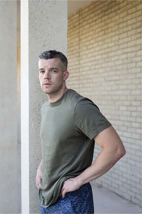 Portrait of Russell Tovey, standing with hands on hips