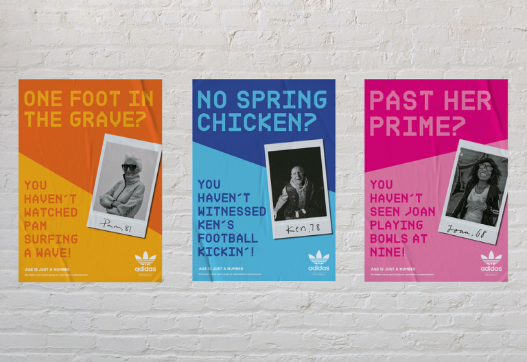 A digital mock-up of three colourful posters on white brick wall.