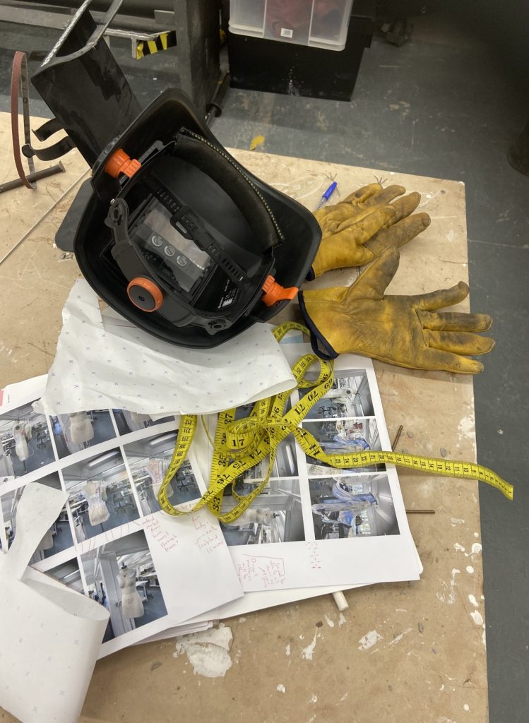 A photo from the 3D workshop of a safety helmet and gloves for welding and handling metal.