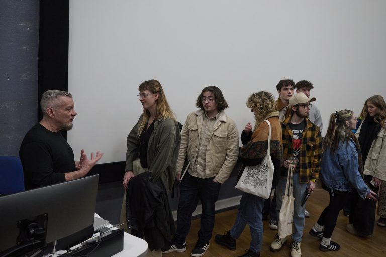 A photo of Neville Brody talking to Norwich graphic students.