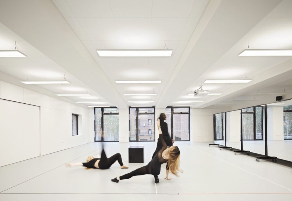 Students in dance studio, they are moving and stretching