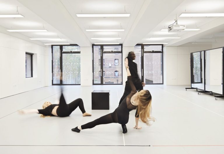 Students in dance studio, they are moving and stretching