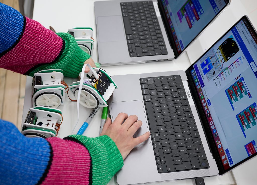 A student working on a laptop in the Creative Tech Lab at Norwich University of the Arts