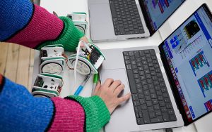 A student working on a laptop in the Creative Tech Lab at Norwich University of the Arts