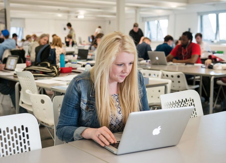 A student working on a macbook in the Graphics Studio