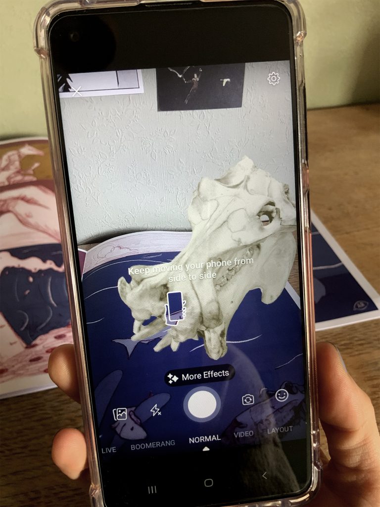 Close up of a phone in camera mode. A skull is shown superimposed onto the phone's camera.