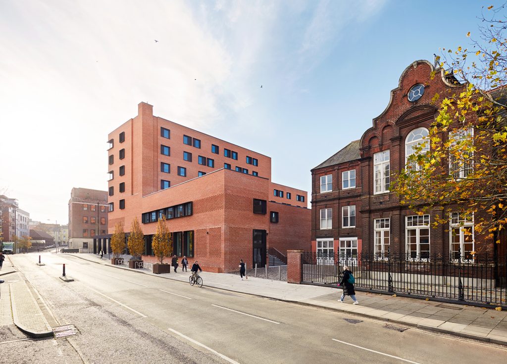 Photo of Norwich Duke Street buildings. There is a blue sky with clouds.