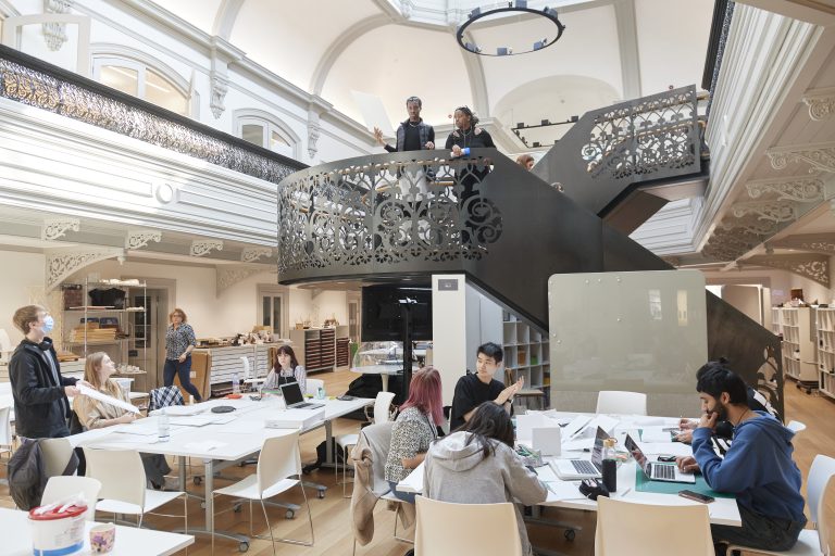 A photograph of various students working and studying at tables in Boardman House.