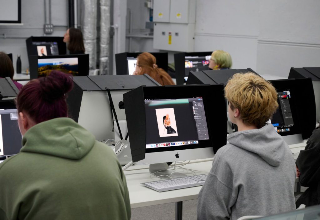 Students working in the digital darkroom on Mac computers.