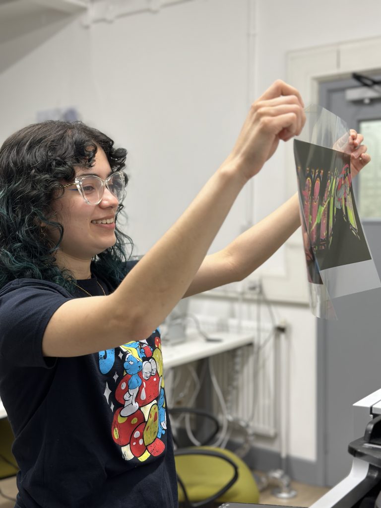 Celeste Jarquín Castillo, Year 0 student holding up acetate paper which she has printed her illustration onto.