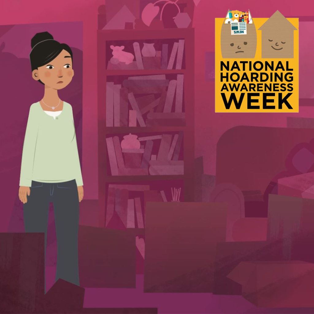 An illustration depicts a concerned woman standing in a cluttered room filled with boxes and various items. A logo for National Hoarding Awareness Week is visible in the upper right corner, featuring two houses with faces and a small building with flags.