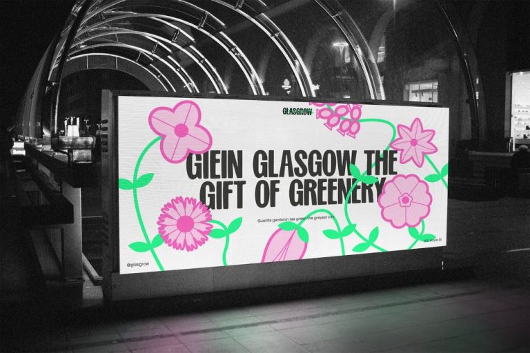 A brightly lit billboard in a modern urban setting displays an advertisement featuring colorful illustrations of flowers with green stems. The text reads, "Giein Glasgow the gift of greenery". The background is black and white, contrasting with the vibrant floral art.