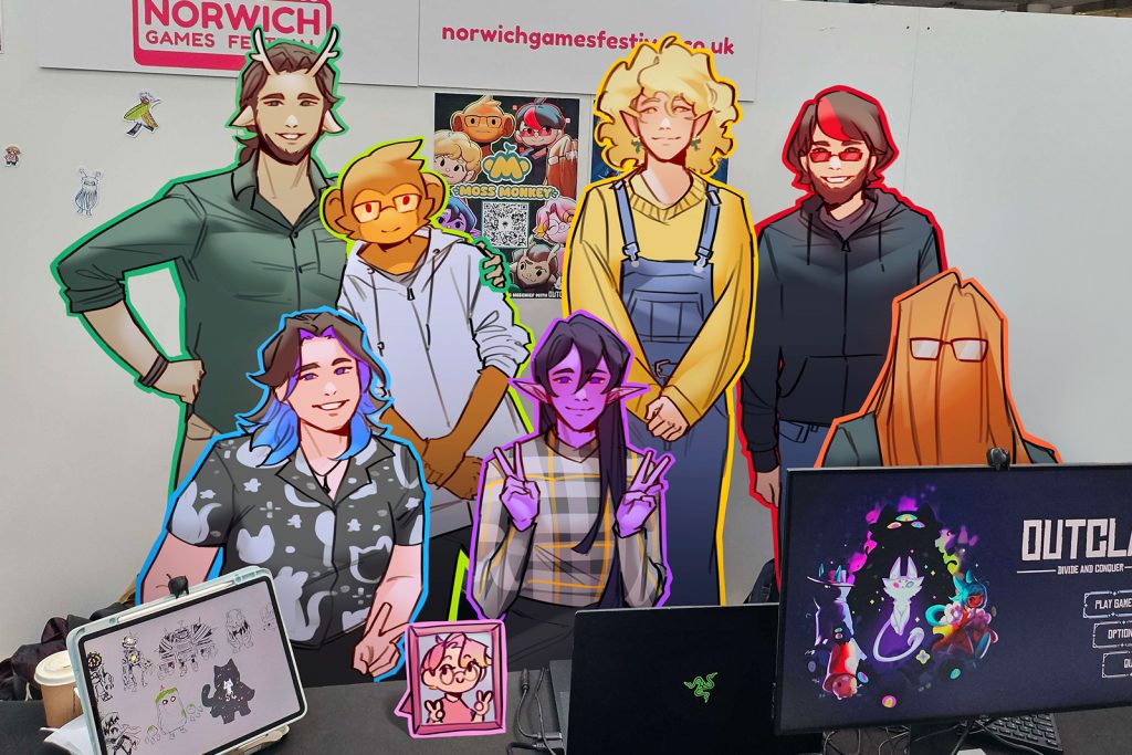 A group of colourfully outlined characters stands behind a table with monitors displaying game graphics. The background features Norwich Games Festival signage.