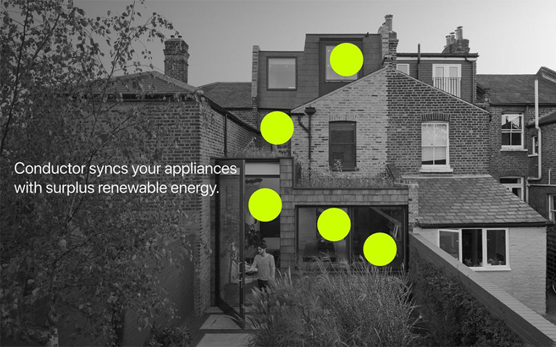 A black and white photograph of the back of a brick house with an extension. Bright green dots are placed on various points of the house. The text reads: "Conductor syncs your appliances with surplus renewable energy.