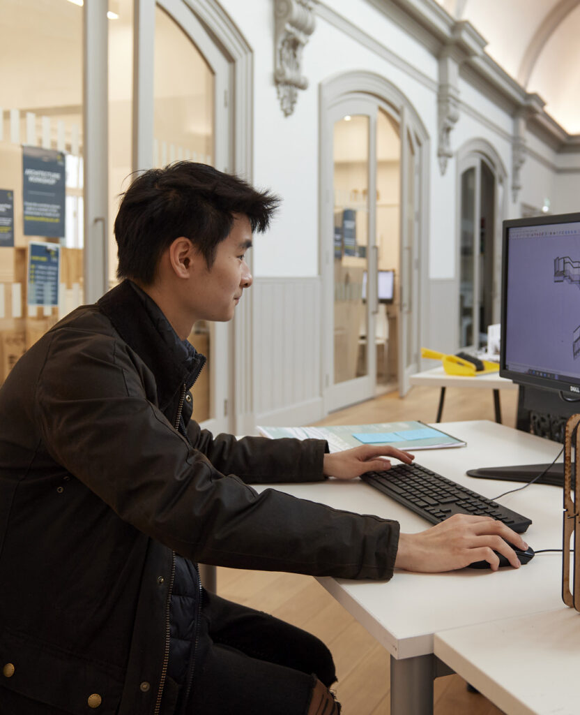 Architecture student on a computer in boardman house