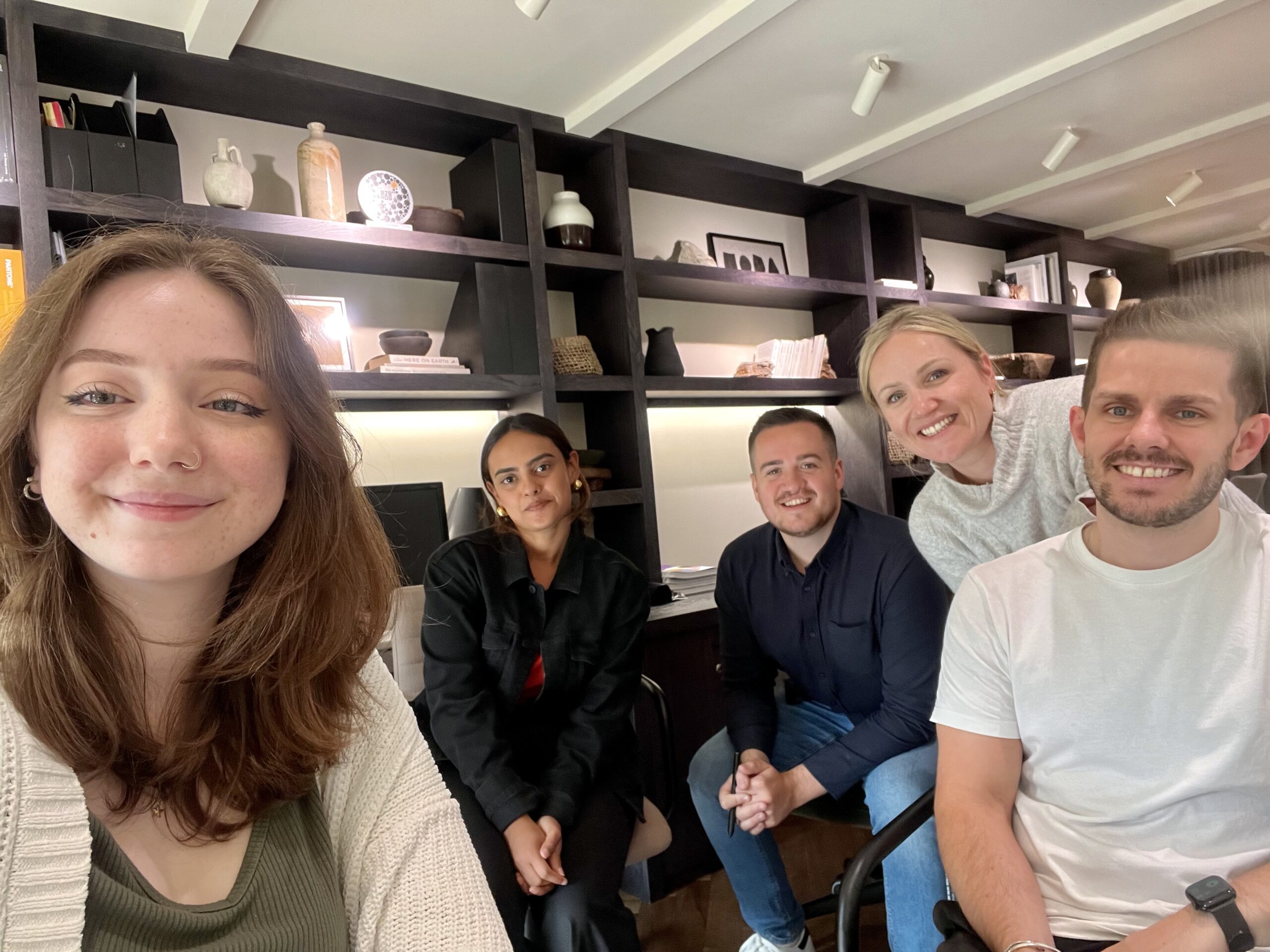 A group of people looking and smiling for a photo.