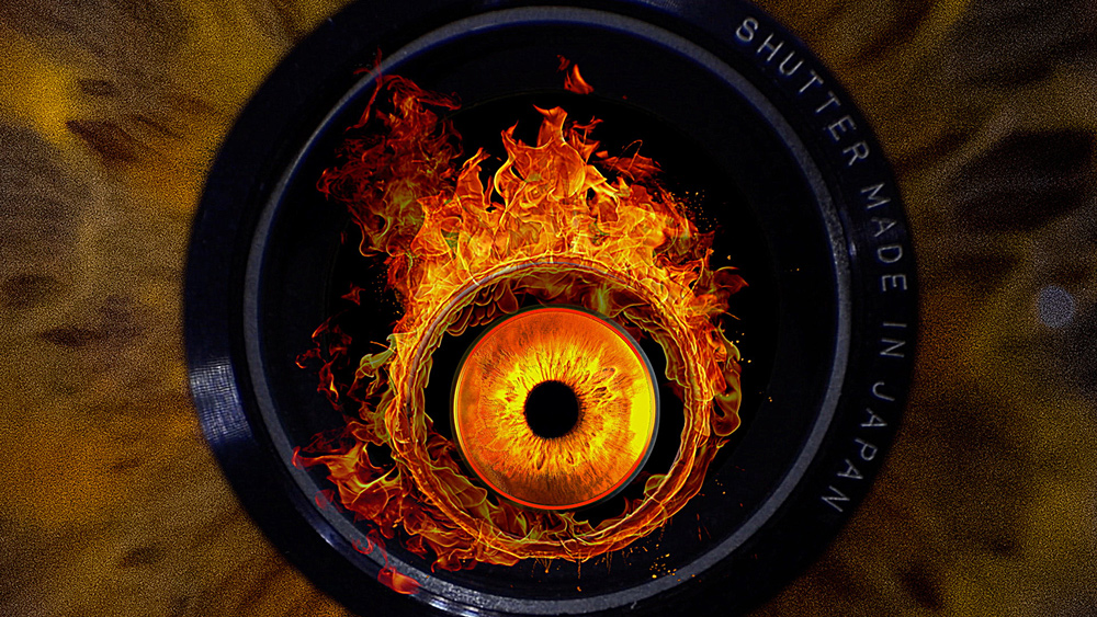 A macro image of a camera lens which has a burning iris inside it. Outside the camera lens looks like the texture of an iris