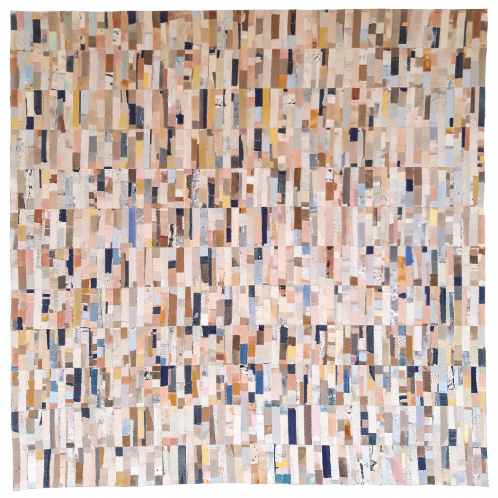 A photograph of a square tapestry made of several scraps of coloured fabrics, with visible stitching to create a patchwork effect.