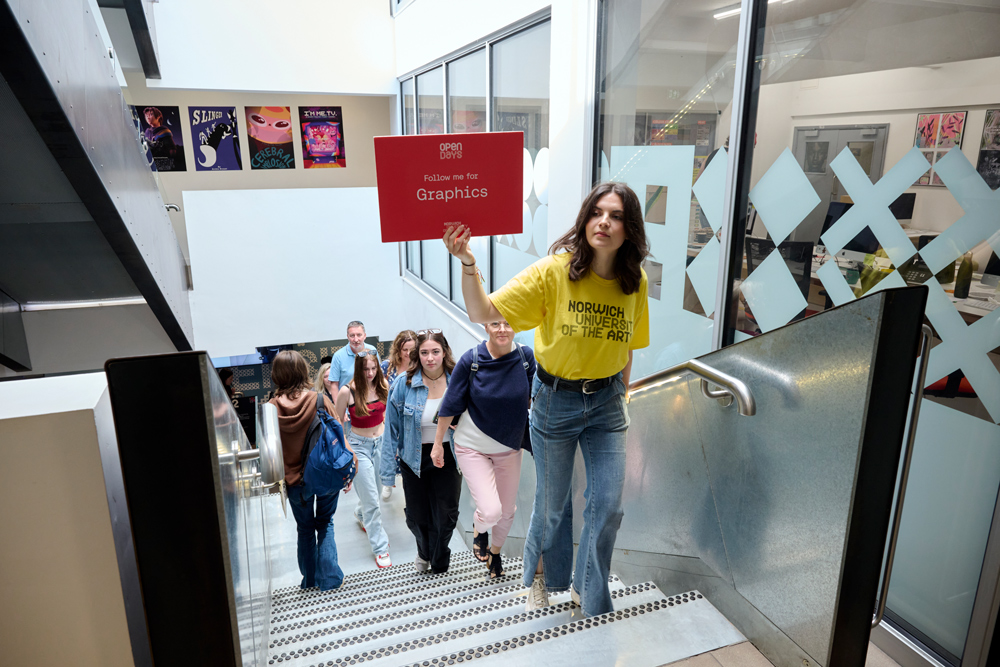 A photograph of a student ambassador for Norwich University of the Arts leading a tour of Guntons Building to Open Day guests