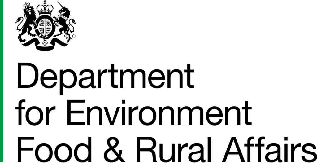 A single thin green vertical line, reminiscent of young shoots in paludiculture, stands on the left edge of a black background. The rest of the image is completely black.