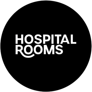 White text on a black background reads "HOSPITAL ROOMS," with the bottom curve of the "R" in "ROOMS" extended to form a smile-like shape, evoking the uplifting murals often found in care spaces.