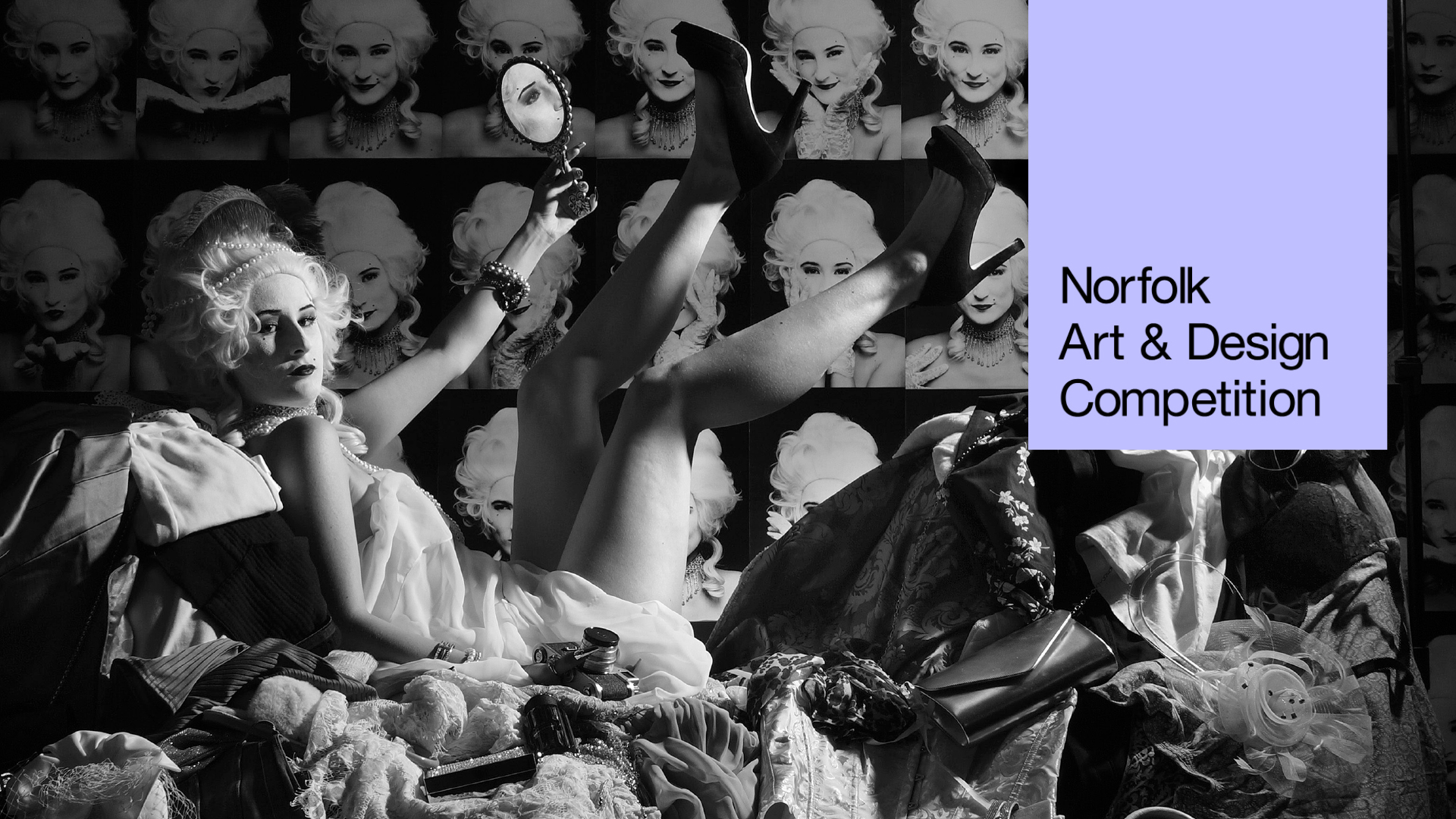 A person in 18th-century-style costume lounges amid clutter, holding a mirror and raising their legs, with pop art portraits of the same person behind. Text reads: "Norfolk Art & Design Competition. Explore our creative arts workshop opportunities.