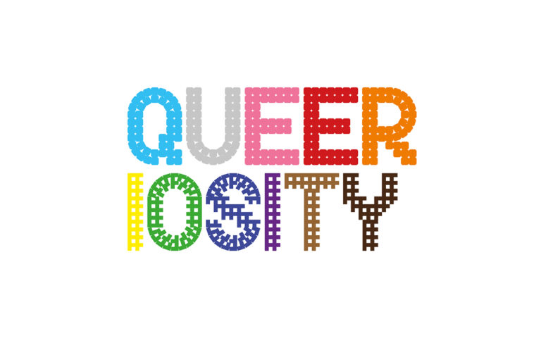Text logo spelling "QUEERIOSITY" in bold, colorful, stitched-style letters on a white background. Each letter is a different color, creating a vibrant and playful appearance.