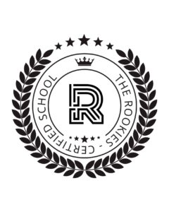 Black and white circular emblem with a stylized "R" in the center, surrounded by the text "THE ROOKIES CERTIFIED SCHOOL," laurel leaves, stars, and a crown at the top.