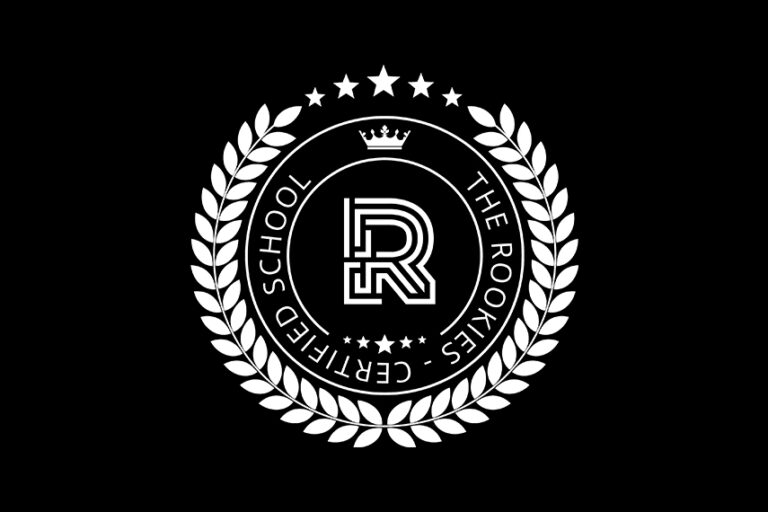 White circular emblem on a black background featuring a stylized "R" in the center, a crown above it, surrounded by laurel branches, stars, and the text "CERTIFIED SCHOOL THE ROOKIES.