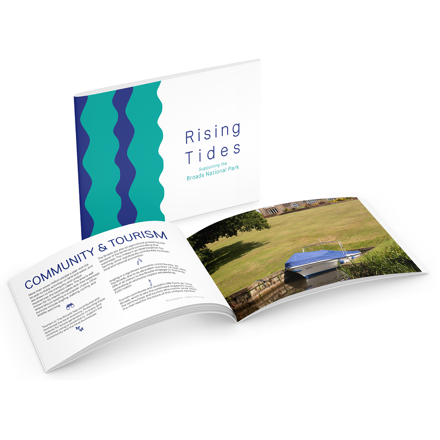 A brochure titled 'Rising Tides: Sustaining the Broads National Park' is shown, with its cover partially open to pages about 'Community & Tourism' and a photo of a blue boat on the water.