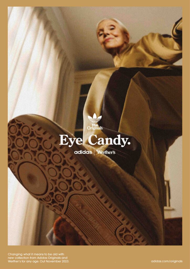 An older woman in beige and brown athletic wear lifts her foot toward the camera, showing the sole of her Adidas shoe. Text reads "Eye Candy. adidas x Werther's." Sunlight streams through curtains in the background.