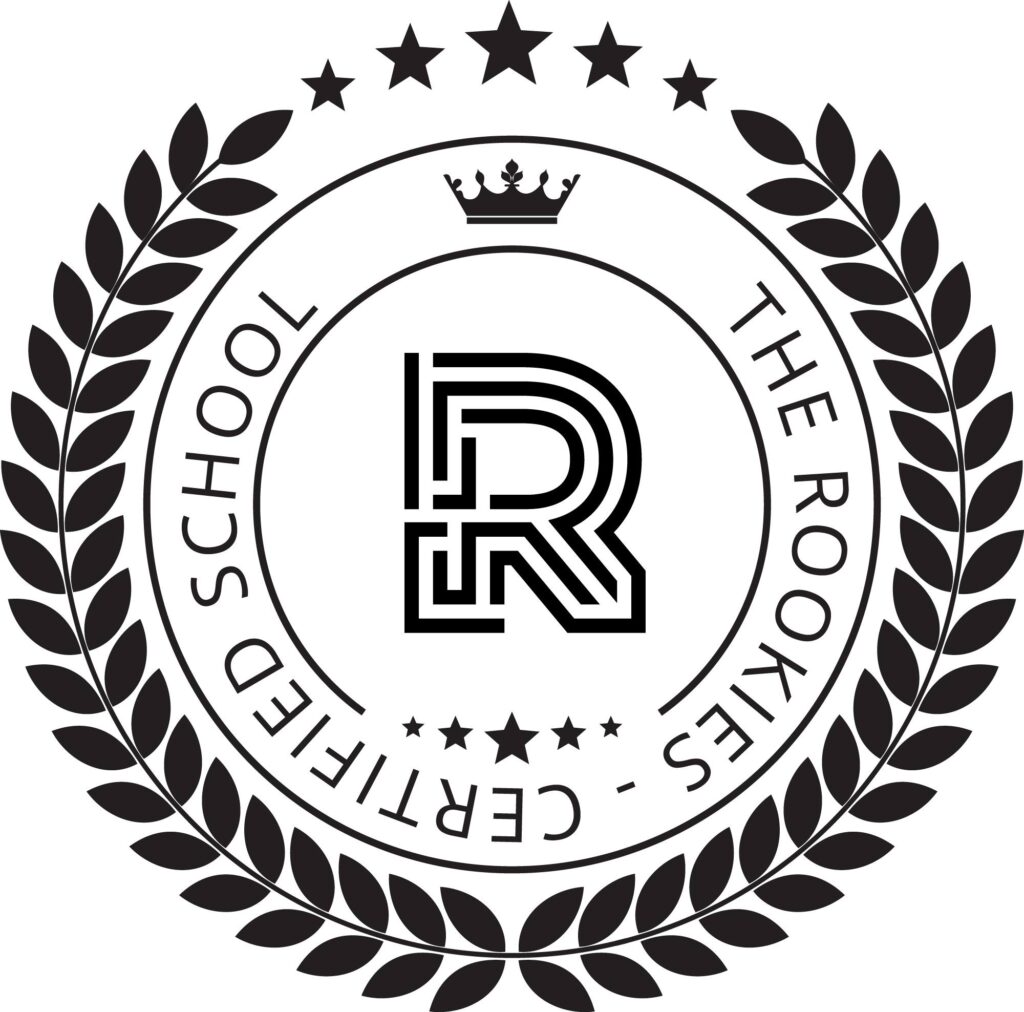 A circular black-and-white emblem with laurel leaves, stars, a crown, and a stylized letter "R" in the center. The text reads "THE ROOKIES - CERTIFIED SCHOOL.