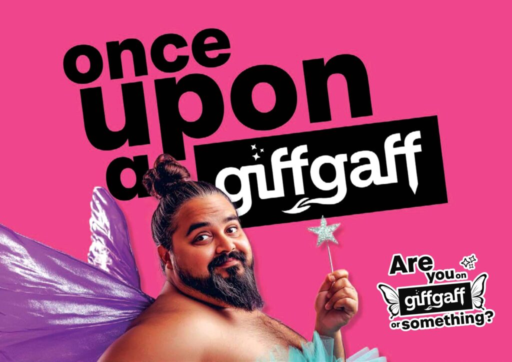 A man dressed as a fairy with purple wings and a blue tutu holds a magic wand, smiling at the camera. The text reads "Once upon a giffgaff" and "Are you on giffgaff or something?" on a bright pink background.
