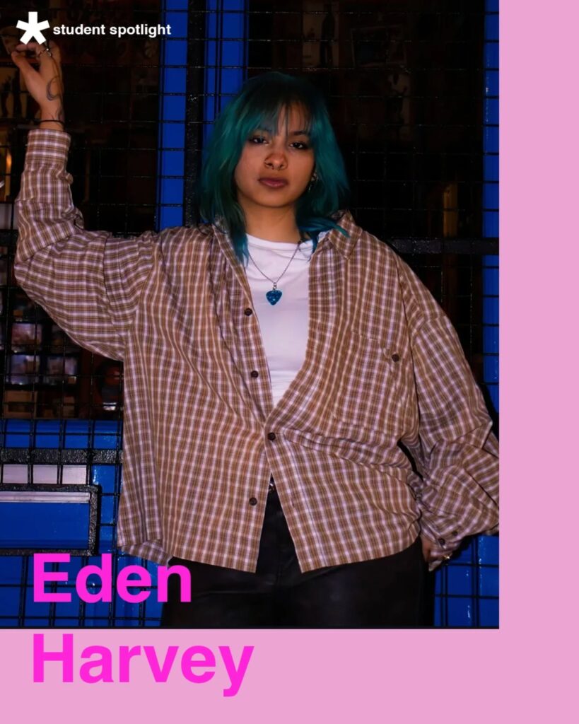 A person with teal hair wearing a brown plaid shirt and white top stands against a blue and black background. Text reads "student spotlight" and "Eden Harvey" in bold pink letters on a light pink border.