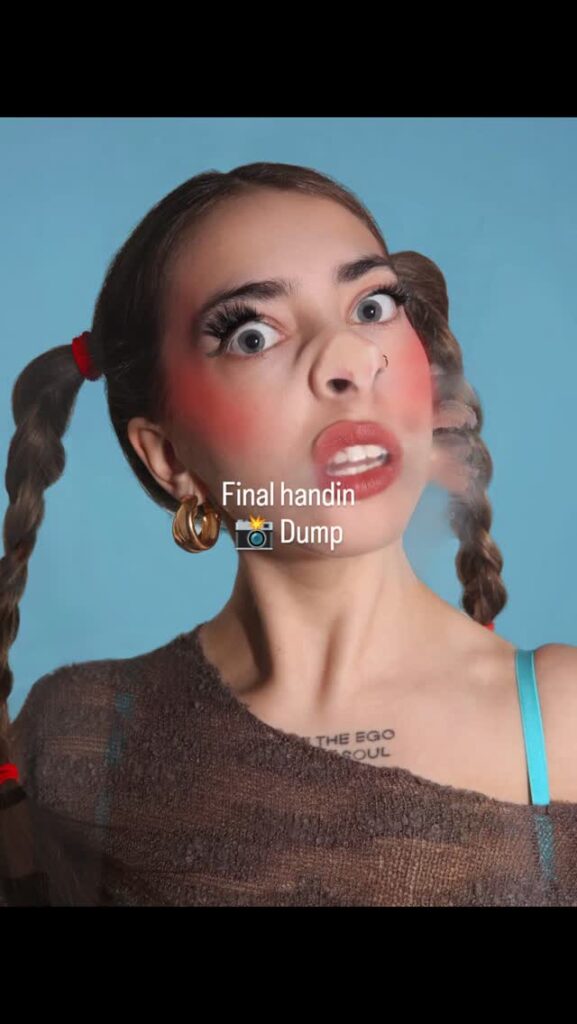 A woman with exaggerated makeup, braided pigtails, and wide eyes poses against a blue background. Text on the image reads “Final handin 📸 Dump.” She wears a nose ring, hoop earring, and visible tattoo.